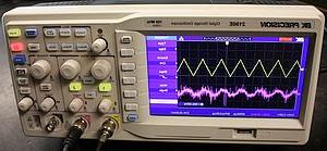 A B&K oscilloscope showing a triangle wave.